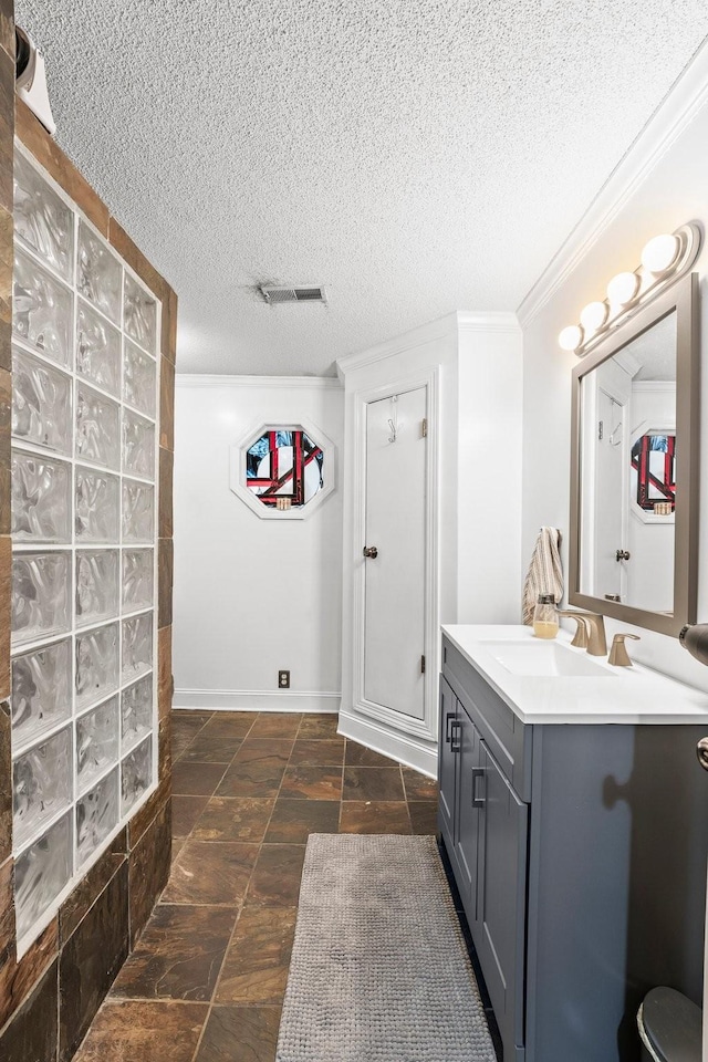 bathroom with vanity, a shower, and a textured ceiling