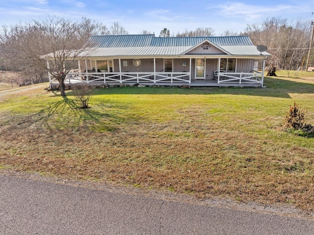 farmhouse with covered porch and a front lawn