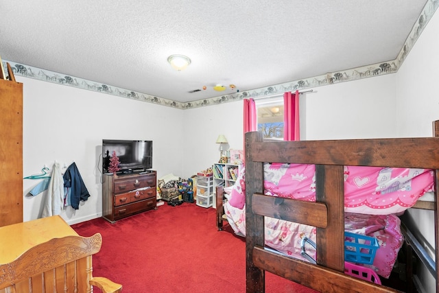 bedroom featuring carpet and a textured ceiling