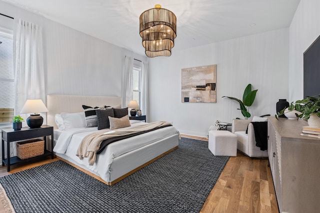 bedroom featuring hardwood / wood-style flooring and an inviting chandelier