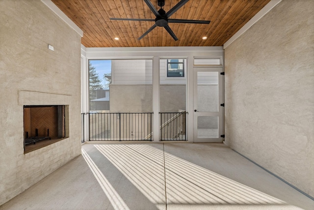 unfurnished sunroom with ceiling fan and wood ceiling