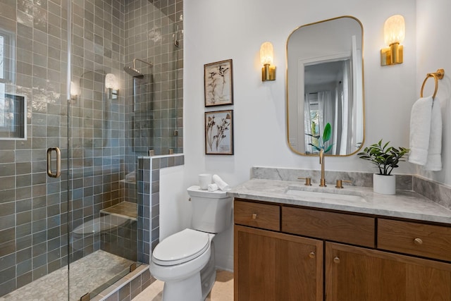 bathroom featuring vanity, toilet, and walk in shower