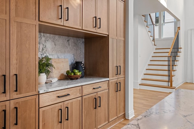 kitchen featuring light hardwood / wood-style flooring and light stone countertops