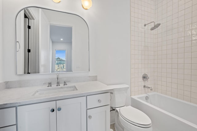 full bathroom featuring tiled shower / bath combo, vanity, and toilet