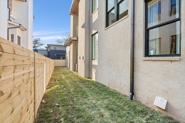 view of property exterior with a yard