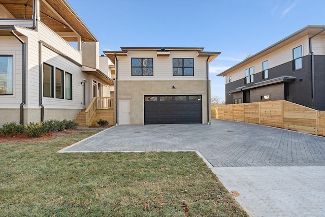 view of front of home featuring a garage and a front lawn