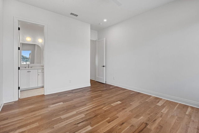 unfurnished room with sink and light wood-type flooring