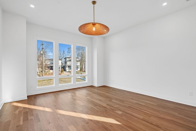 unfurnished dining area featuring wood-type flooring and plenty of natural light