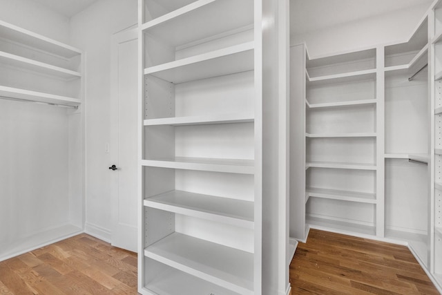 walk in closet with hardwood / wood-style floors