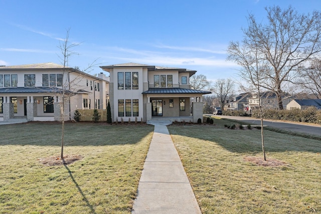 view of front of home with covered porch and a front lawn