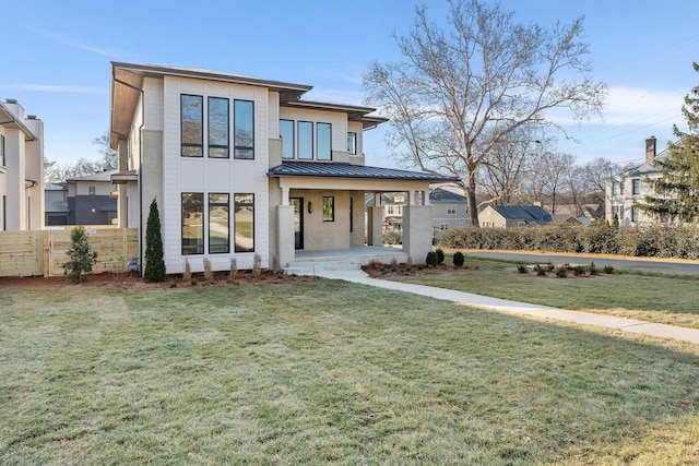 view of front of property featuring a carport and a front lawn