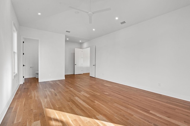 unfurnished bedroom with connected bathroom, light hardwood / wood-style floors, and ceiling fan