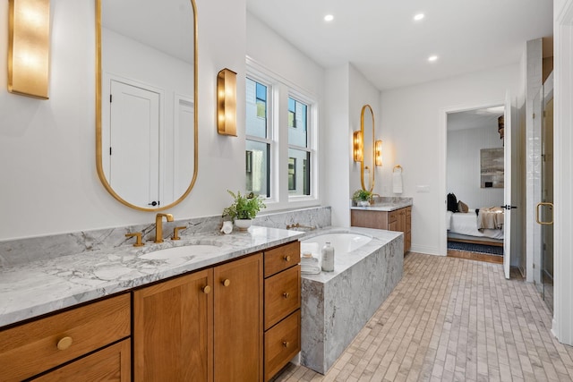 bathroom featuring tile patterned floors, vanity, and tiled tub