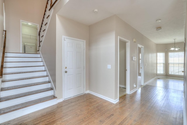 entrance foyer featuring a chandelier and light wood-type flooring