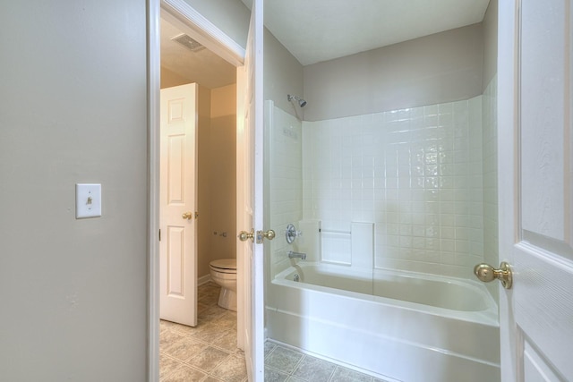 bathroom featuring toilet and bathing tub / shower combination