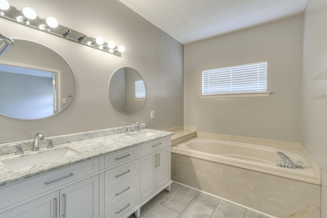 bathroom with vanity, a tub to relax in, and tile patterned floors