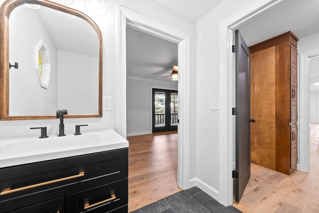 bathroom with french doors, vanity, ornamental molding, ceiling fan, and hardwood / wood-style floors
