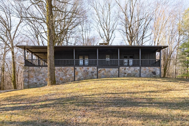 rear view of property featuring a yard
