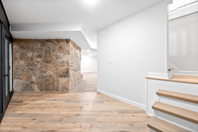 corridor with light hardwood / wood-style flooring
