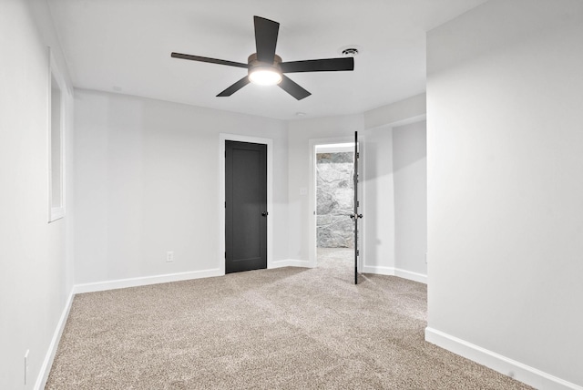 carpeted empty room featuring ceiling fan