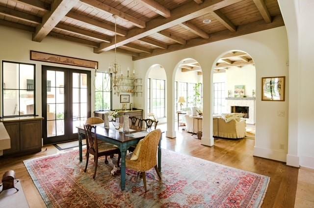 dining room with hardwood / wood-style flooring, french doors, beamed ceiling, and wood ceiling