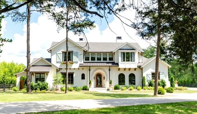 view of front of home with a balcony and a front yard