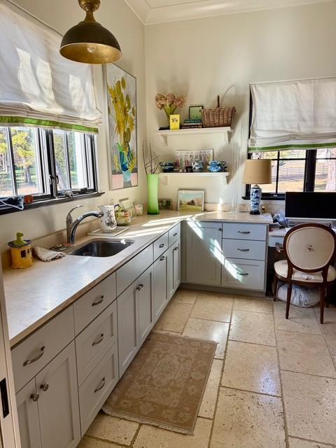 kitchen with sink, pendant lighting, and crown molding