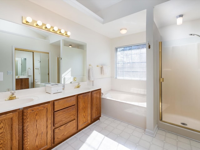 bathroom featuring vanity and shower with separate bathtub