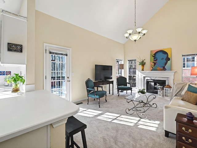 living room with an inviting chandelier, high vaulted ceiling, light colored carpet, and a premium fireplace