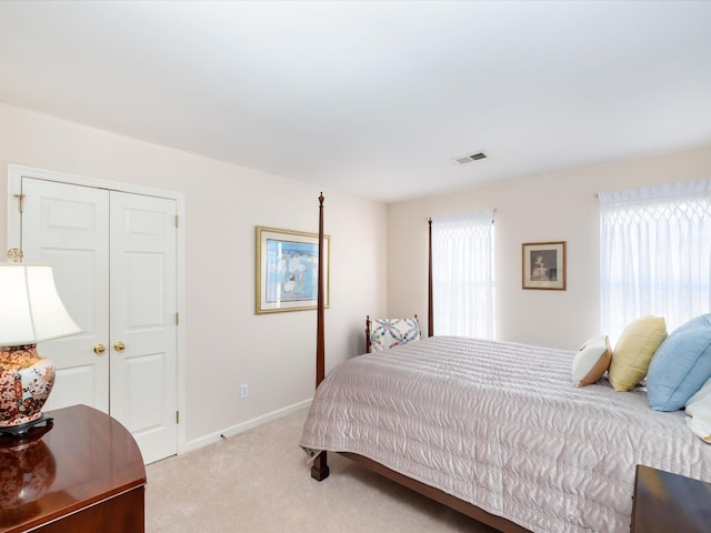 carpeted bedroom with a closet