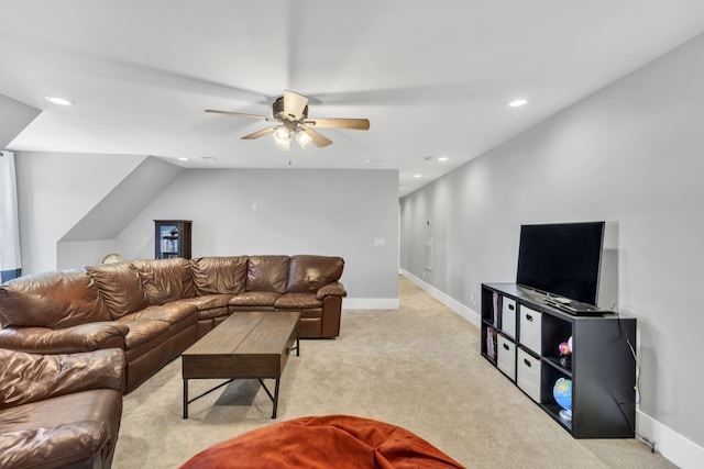 living room with ceiling fan, lofted ceiling, and light carpet