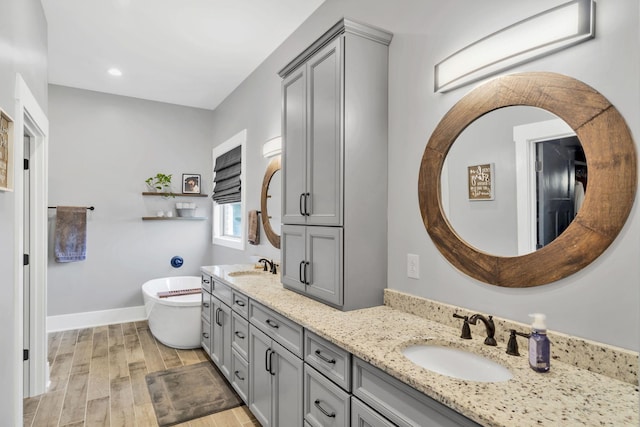 bathroom with vanity and a tub