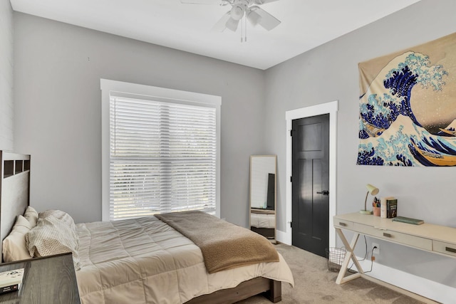 carpeted bedroom featuring multiple windows and ceiling fan