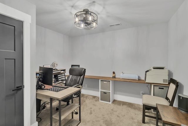 office space featuring an inviting chandelier and light colored carpet