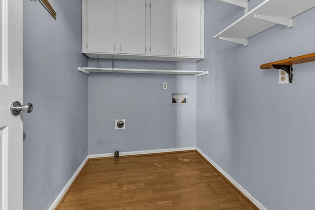 laundry room featuring hookup for a washing machine, wood-type flooring, electric dryer hookup, and cabinets