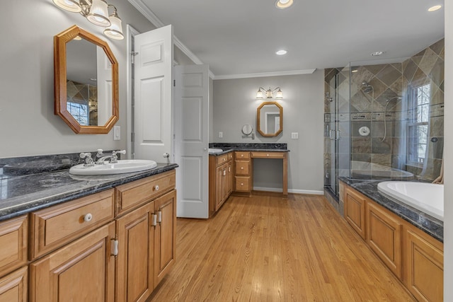 bathroom featuring vanity, hardwood / wood-style floors, ornamental molding, and independent shower and bath