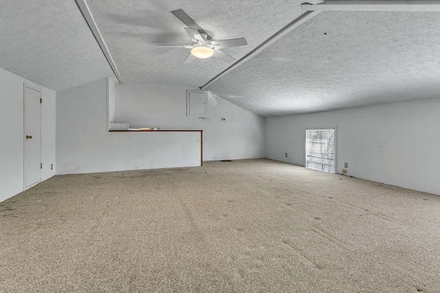 bonus room featuring vaulted ceiling, carpet, and a textured ceiling