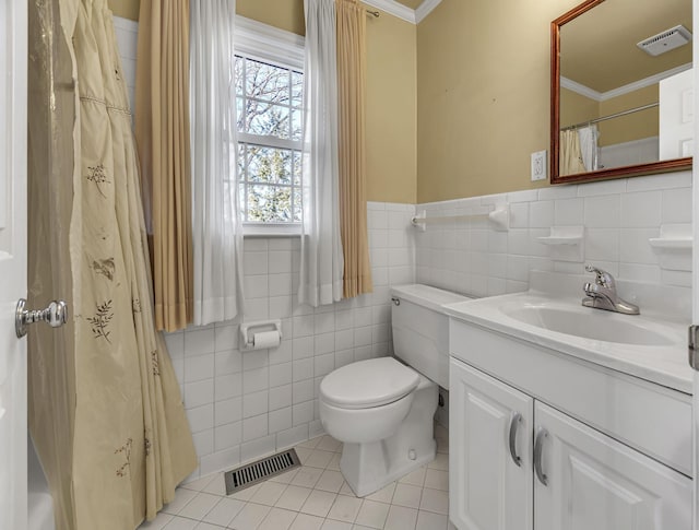 bathroom featuring tile walls, tile patterned flooring, vanity, toilet, and crown molding