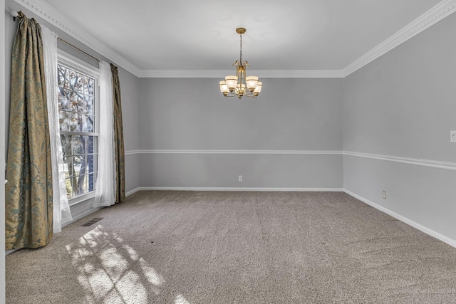 spare room featuring ornamental molding, carpet flooring, and a chandelier