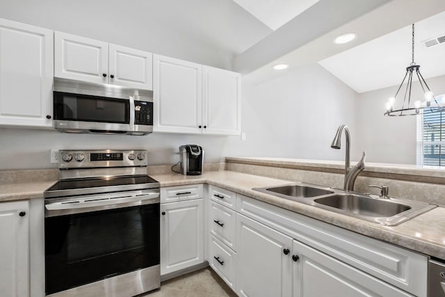 kitchen with white cabinetry, appliances with stainless steel finishes, sink, and pendant lighting