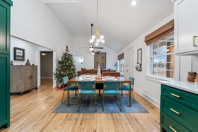 dining area featuring ceiling fan, vaulted ceiling, and light hardwood / wood-style floors