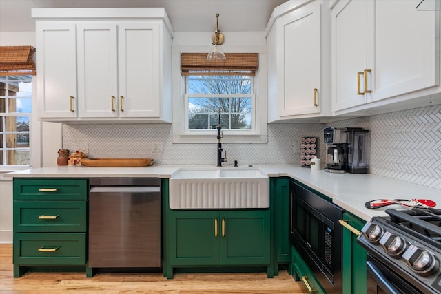 kitchen with sink, backsplash, white cabinets, and appliances with stainless steel finishes