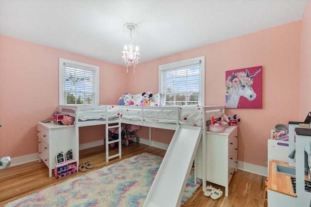 bedroom with a notable chandelier and light hardwood / wood-style flooring