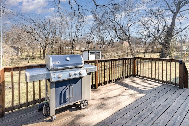 deck featuring a grill and a storage unit