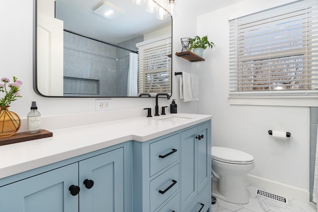 bathroom with vanity, curtained shower, and toilet