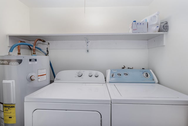 washroom with water heater and washer and dryer