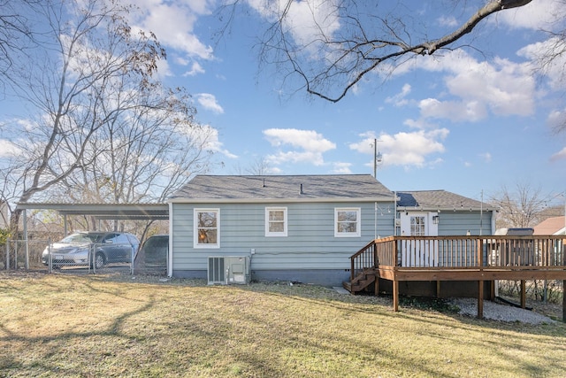 rear view of house featuring a carport, a yard, a deck, and central air condition unit