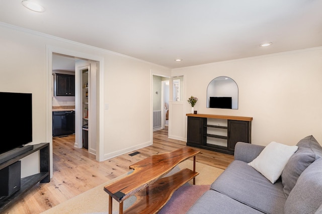 living room featuring crown molding and light wood-type flooring