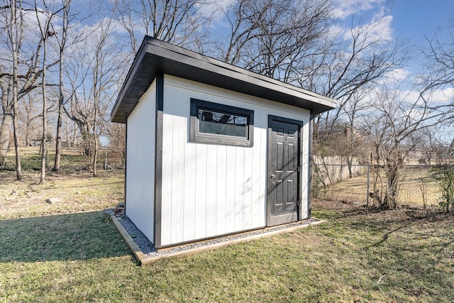 view of outbuilding with a yard