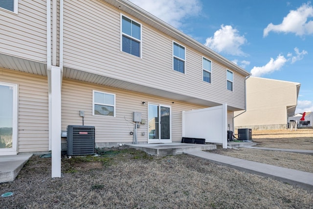 rear view of property with central AC and a patio area